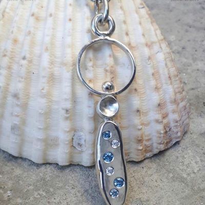 Stepping Stones silver pendant with bright blue stones with