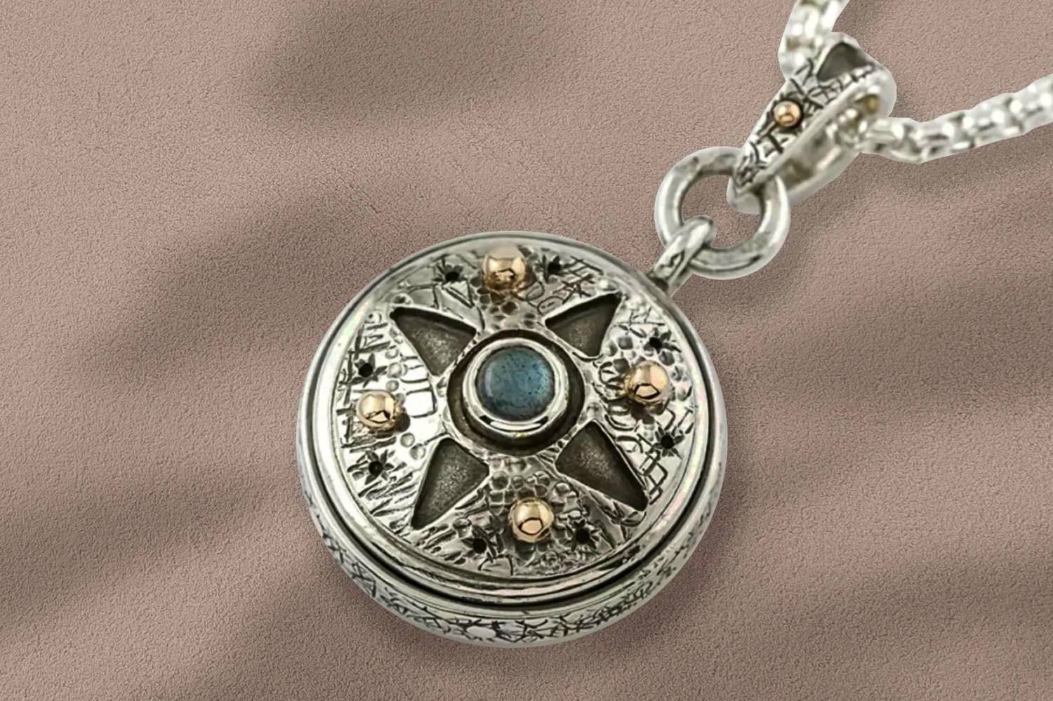 Handmade working silver compass pendant on sandstone